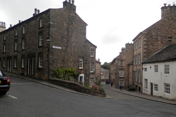 Castle Hill is the street on the right going down the hill. This is directly opposite Lancaster Castle