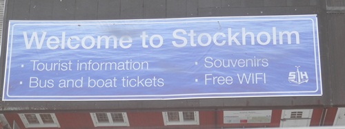 the welcome sign on top of the souvenir building at Stockholm as seen from the ship
